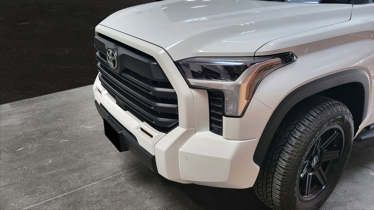 Gloss white Fog Lamp Bezel Overlay fully installed on a 2022 Toyota Tundra, highlighting the seamless integration with the vehicle's design.