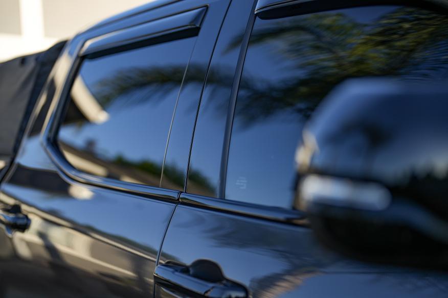 palm trees reflecting in the background of a Toyota Tundra sporting Shellz Window Trim kit