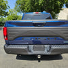 Tailgate Applique installed on a 2015-2020 F150, showcasing the enhanced look to the tailgate, with the truck positioned parked outside a business