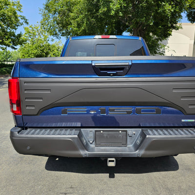 Tailgate Applique installed on a 2015-2020 F150, showcasing the enhanced look to the tailgate, with the truck positioned parked outside a business