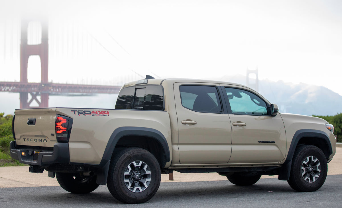 Quicksand colored Toyota Tacoma sporting Matte Black BumperShellz overlooking the golden gate bridge