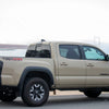 Quicksand colored Toyota Tacoma sporting Matte Black BumperShellz overlooking the golden gate bridge