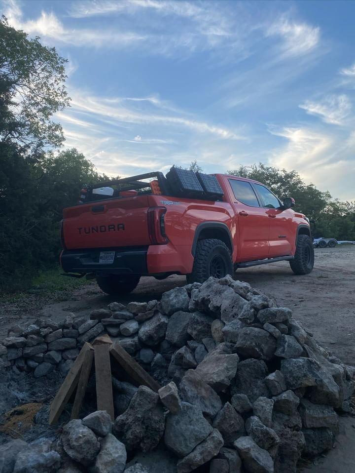 matte black rear bumper covers installed on a 2022-2024 Toyota Tundra parked at a camp site, chrome delete off-roading