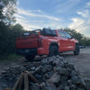 matte black rear bumper covers installed on a 2022-2024 Toyota Tundra parked at a camp site, chrome delete off-roading