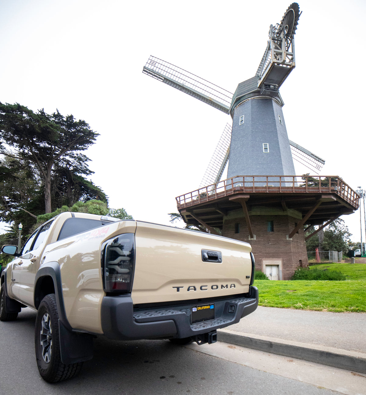 Toyota Tacoma with matte black bumpershellz parked outside windmill, ready for adventure