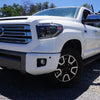 Up-close shot of a 2014-2021 Toyota Tundra with Super White BumperShellz on the front bumper, featuring sensor holes for the 2.5 generation Tundra, captured during the day