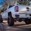 Olympic White rear bumpershellz installed on a 2018 Chevy Silverado, parked outside with a fresh black out kit