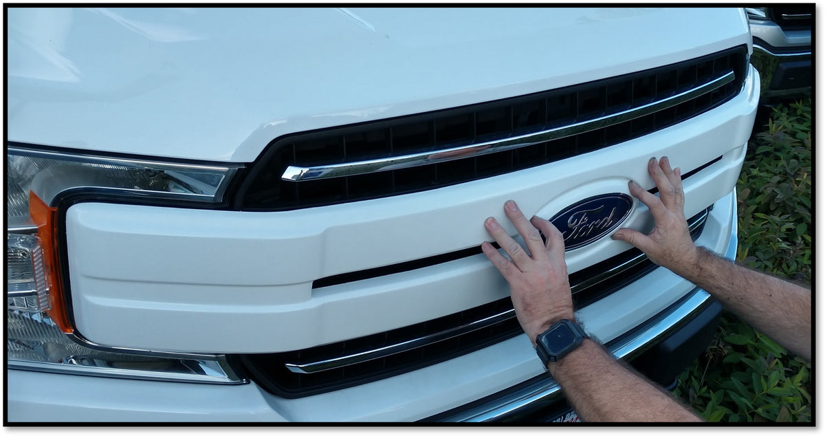Gloss White Center Bar Grille Overlay in the process of installation on a 2018-2020 F150 grille, demonstrating the ease of adding a chrome delete look.