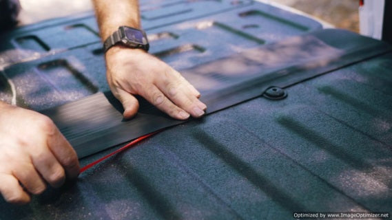 "Photo of hands effortlessly installing the GapShield Universal Tailgate Gap Cover on a truck bed, illustrating the simple, no-tools-required setup