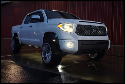 Super White II 2014-2021 Toyota Tundra at night with headlights and fog lamps on sporting BumperShellz Hood Bulge and Grille Surround overlays