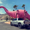 Toyota Tundra equipped with Gloss Black BumperShellz rear overlays, parked outside the iconic Pink Dinosaur landmark in Cabazon, CA – showcasing the truck's customized appearance.